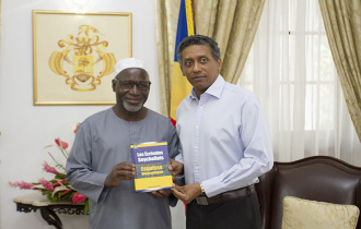 President Faure receives a copy of book The Seychellois Writers by local writer Abdourahamane Diallo