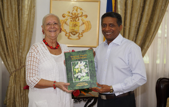 President Faure presented with the first copy of “Tropical plants in Seychelles”